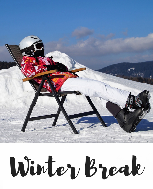 Skier sitting in chair on mountain with snow