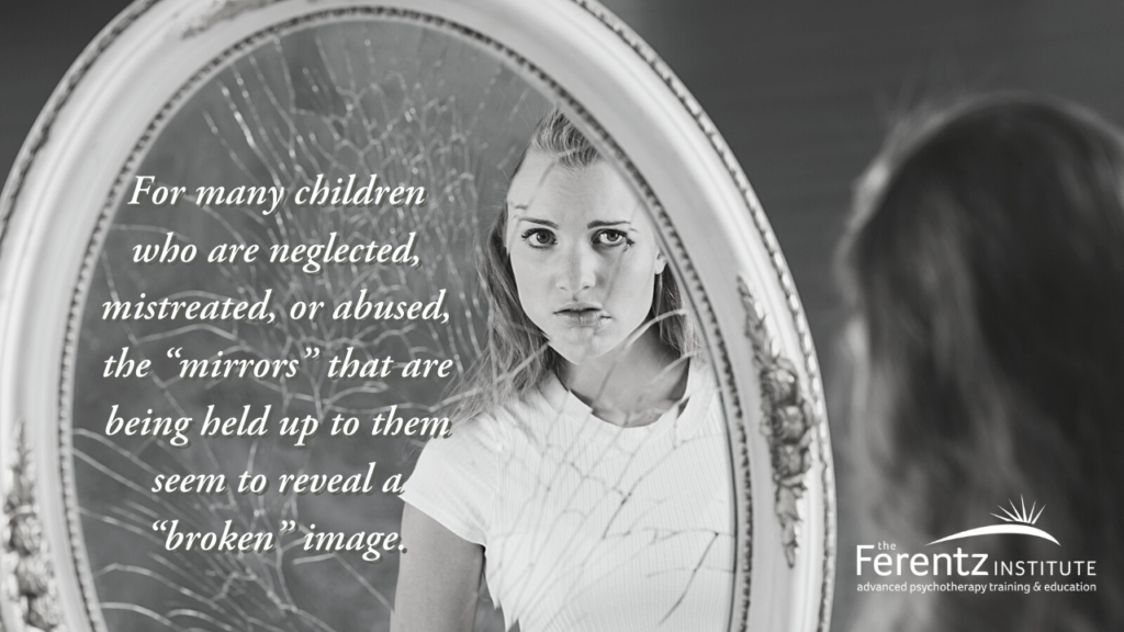 Young teenage girl looking into a broken mirror