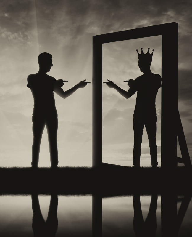 Man looking in a full-length mirror viewing himself as a king